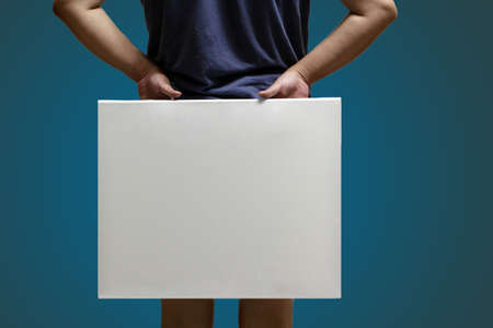 The dark blue clothes, the back of the body, the hand drawing boardの写真素材