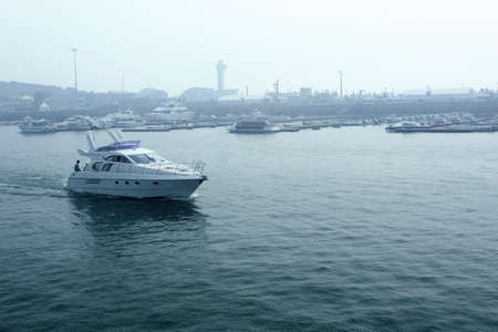 Blue sea fast out of harbour and yacht の写真素材