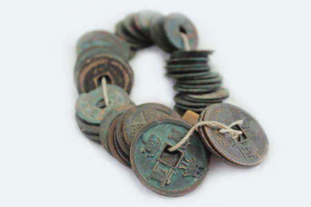 Metal coins of white background always Chinese ancient overgrown with patinaの写真素材