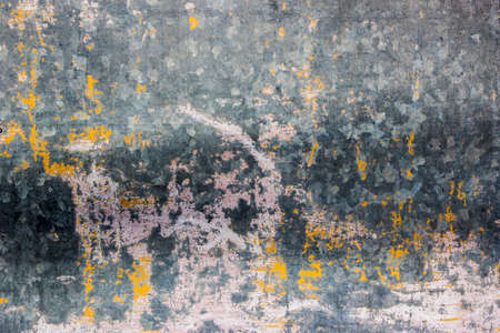 Mottled colors covered with scratches stains of the wallの写真素材
