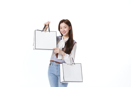 Young beautiful woman showing shopping bagsの写真素材