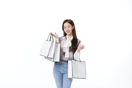 A woman with a shopping bag with a happy expressionの写真素材