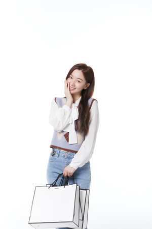 A woman with a shopping bag with a happy expressionの写真素材
