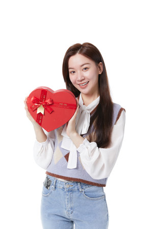 Young beautiful woman showing gift box with happy expressionの写真素材