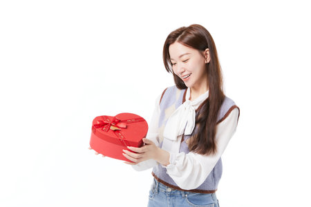 Energetic woman receiving gift with happy expressionの写真素材