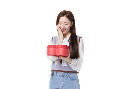 Young woman receiving gift box with happy expressionの写真素材