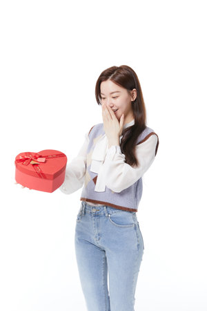 Energetic woman receiving gift with happy expressionの写真素材