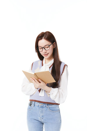 Classmates in glasses reading books with booksの写真素材
