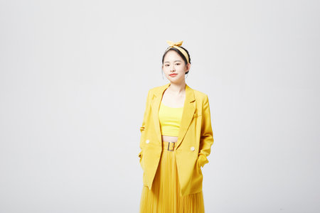 Half-length image of working woman with hands in pocketsの写真素材