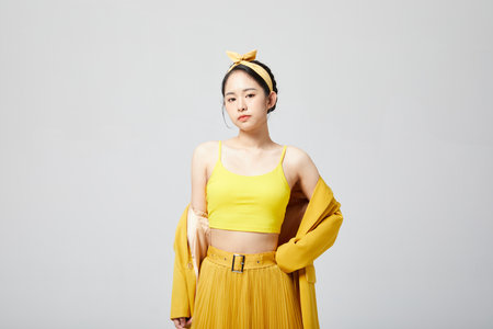girl in yellow camisole akimboの写真素材
