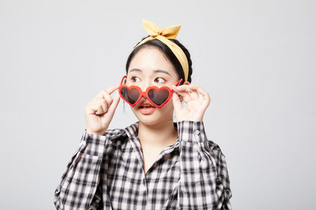 Energetic woman wearing red heart sunglassesの写真素材