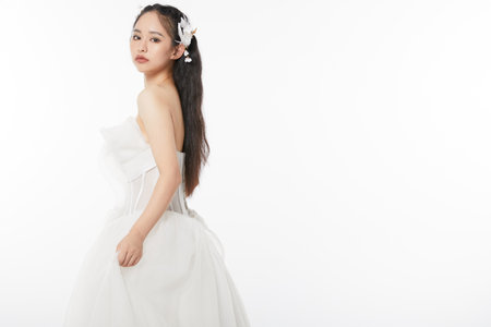 Bride in white wedding dress looking sideways at cameraの写真素材