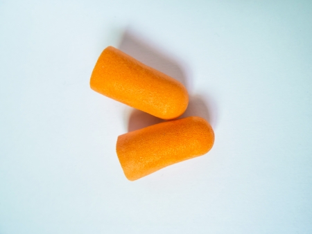 orange earplug isolated on white backgroundの写真素材