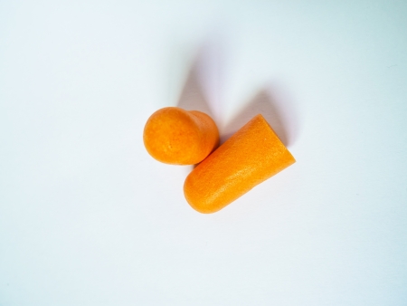 orange earplug isolated on white backgroundの写真素材