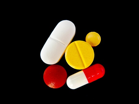 color medicine isolated on black backgroundの写真素材