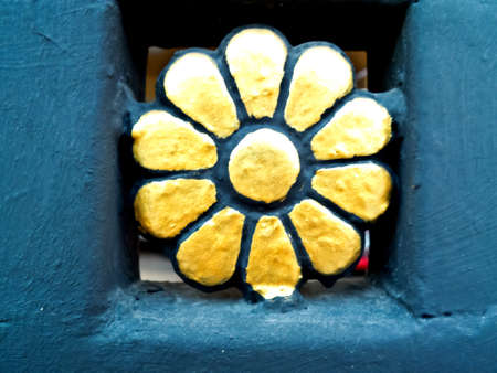 one gold flower isolated texture on black backgroundの写真素材