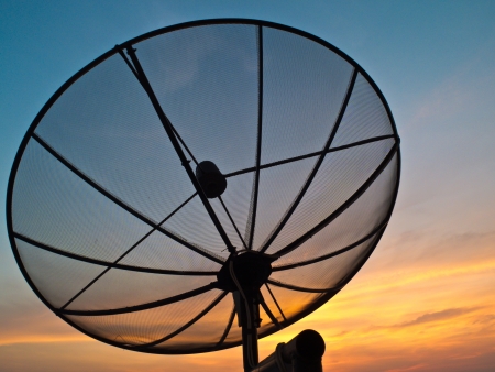 a satellite dish in background sky on sunsetの写真素材