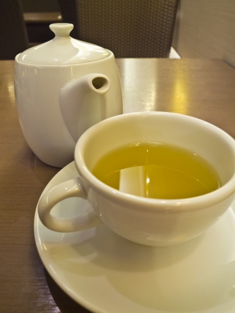 green tea in white cup and teapotの写真素材