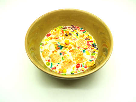 colorful cereals and milk in bowl on white backgroundの写真素材