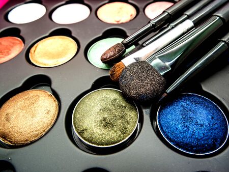 used multi-color cosmetic cushion, eye shadow, eye liner brusher, lip, highlight, shading selective focusの写真素材