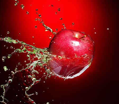 red apple in juice streamの写真素材