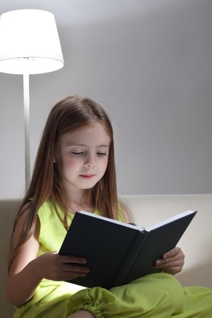 beauty girl read book on sofaの写真素材