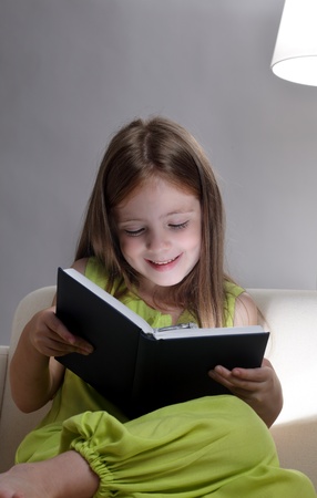 beauty girl read book on sofaの写真素材