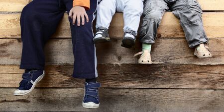 three boy on wood deckの写真素材
