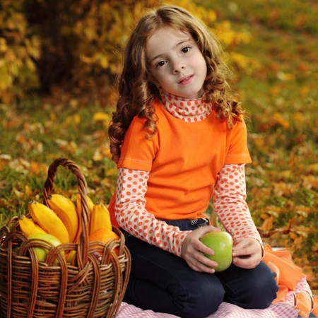 girl with fruit in parkの写真素材
