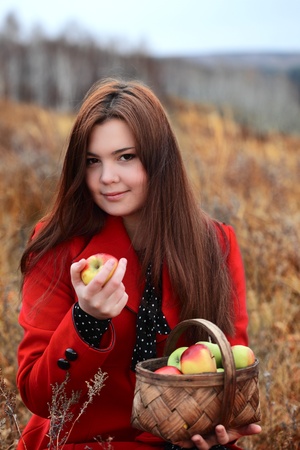 beauty girl with apple outdoorsの写真素材