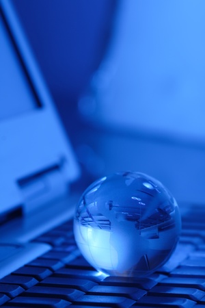 glass globe on keyboardの写真素材
