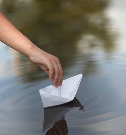 paper ship in children handの写真素材