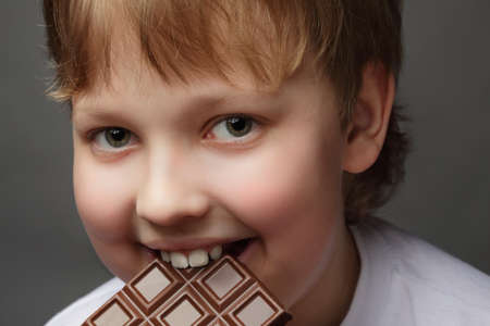 happy boy with chocolate barの写真素材