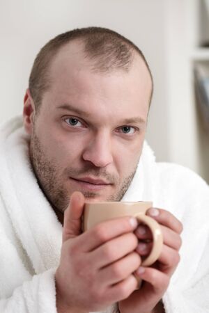 frozen man with tea cupの写真素材