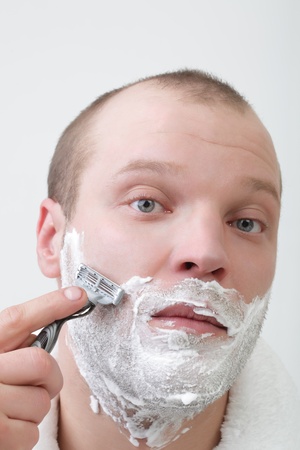 young man shave isolate on whiteの写真素材