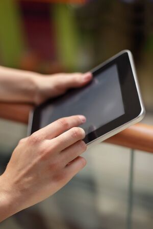 tablet computer in girl hands indoorsの写真素材