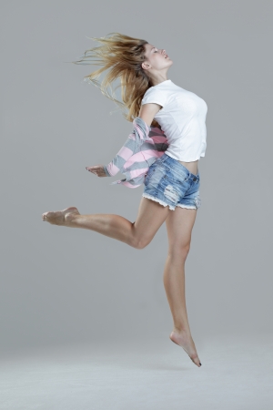 beauty girl dance on grey backgroundの写真素材