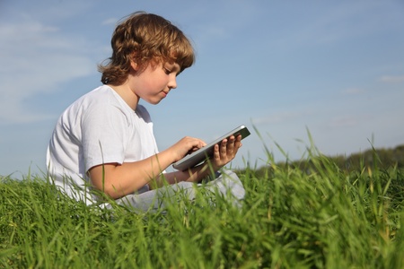 Boy with tablet pc outdoors