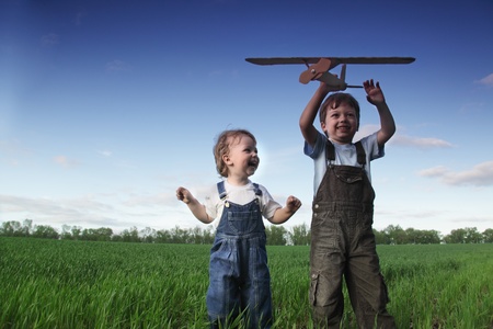 children with airplane toy outdoorsの写真素材
