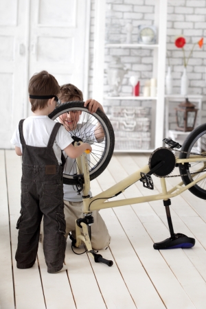 two boy  repairing bicycleの写真素材