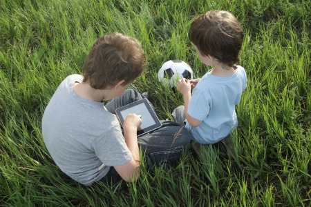 Boy with tablet pc outdoorsの写真素材