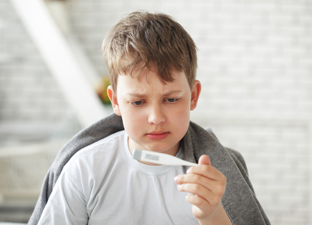 teen measures the temperature of the bodyの写真素材