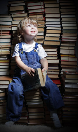 children reach for a bookの写真素材