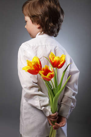 little boy hides behind surpriseの写真素材