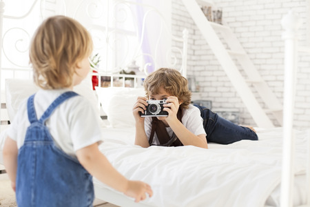 happy boy with retro cameraの写真素材