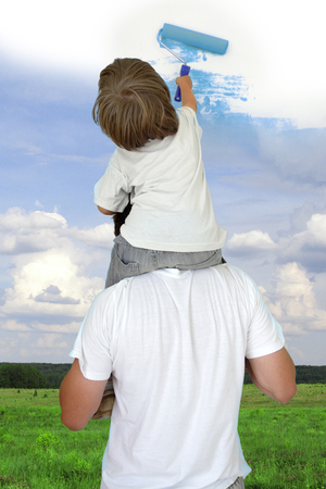 Dad helping son to draw good weather collageの写真素材