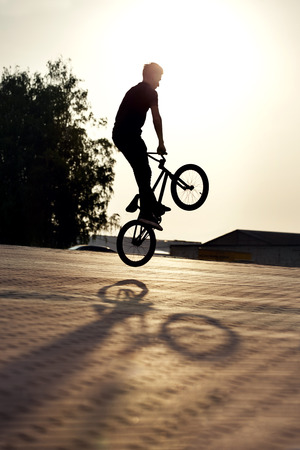 teenager jump on a bicycle outdoorsの写真素材