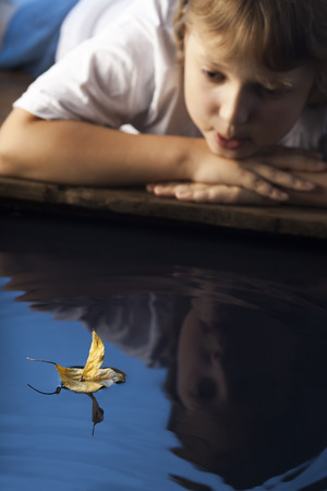 leaf ship in children hand, focus on handの写真素材