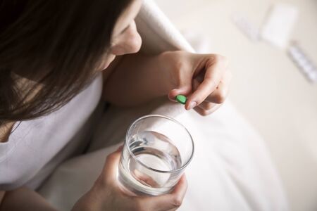 she dissolves a pill for the treatment ofの写真素材
