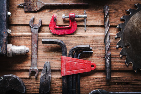 grungy old tools on a wooden background (processing cross-process)